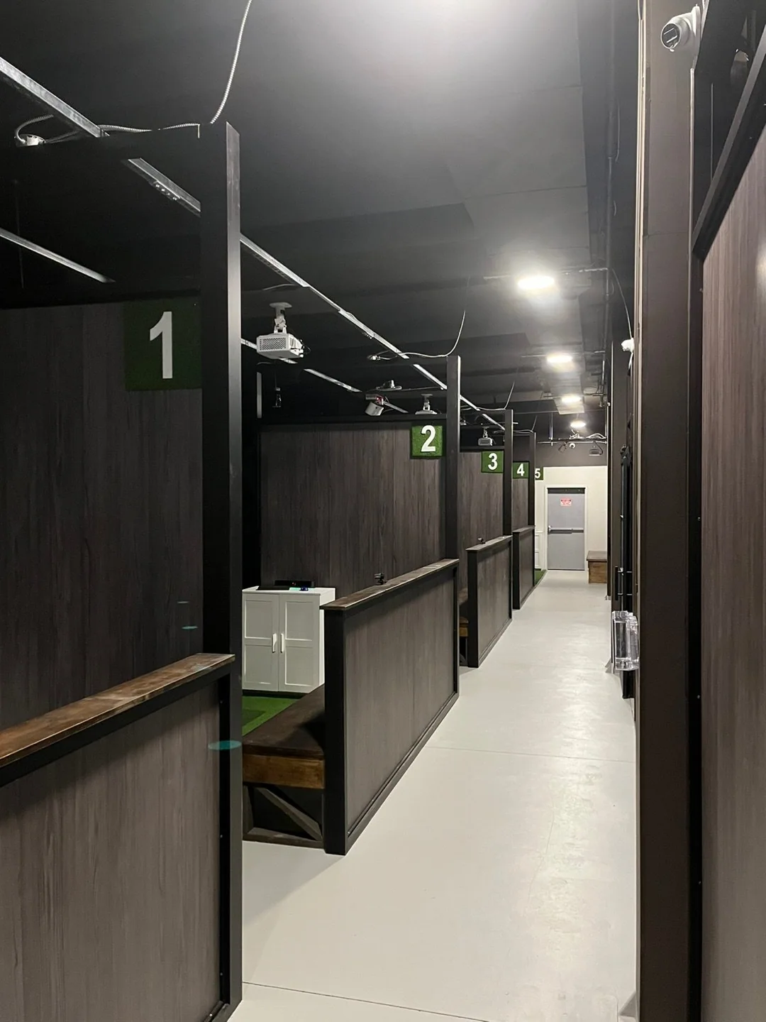 A shared walkway beside enclosed simulator bays